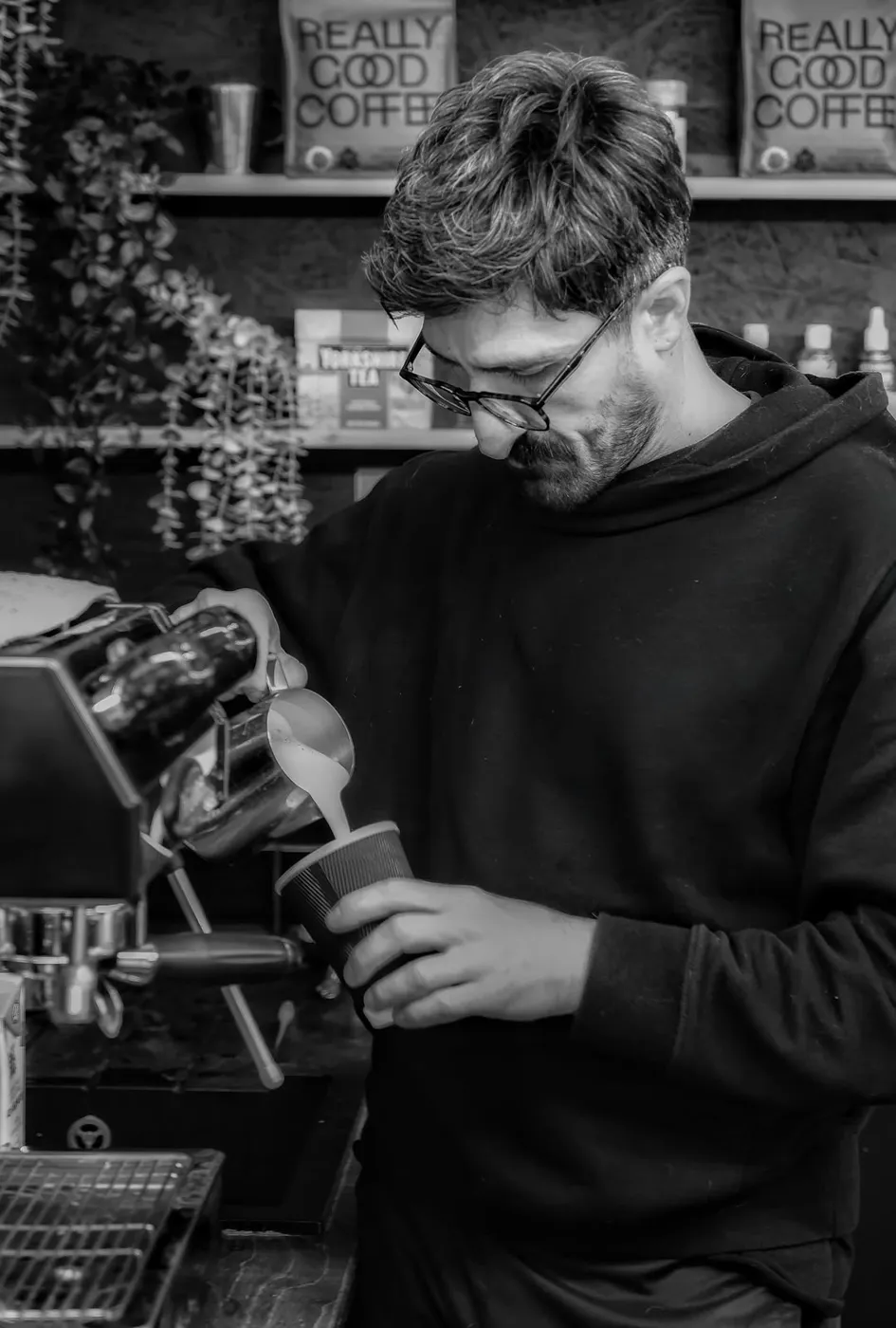 Ilko Tomov pouring at the machine in Darkroom Coffee House